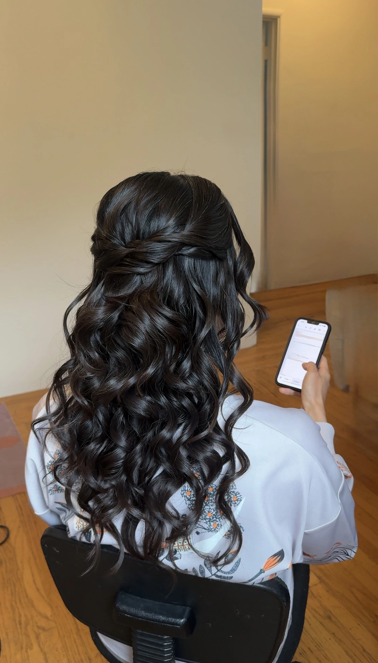 Half-up hairstyle with intertwined sections and cascading curls