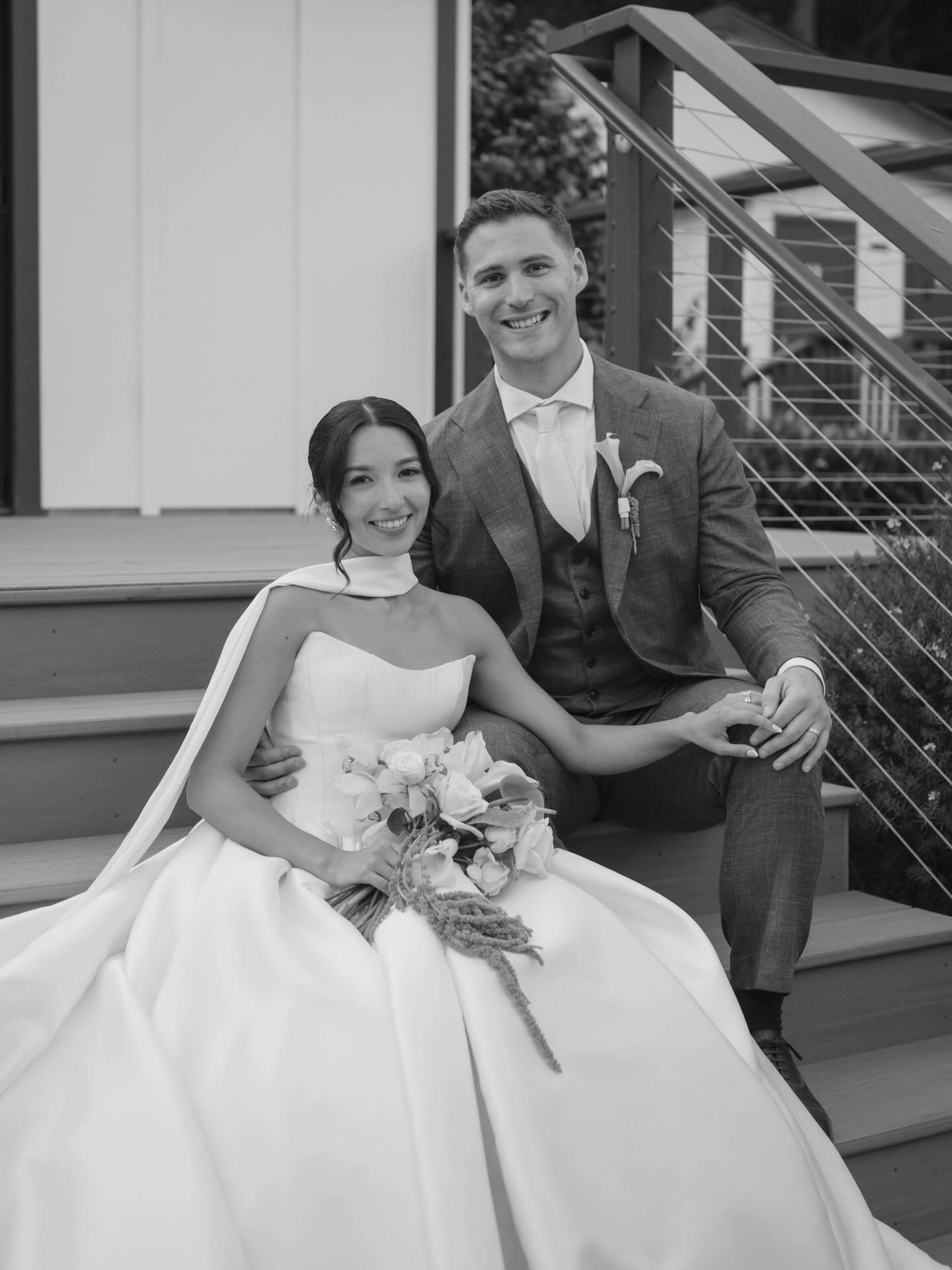 Black-and-white wedding portrait of a bride and groom seated together