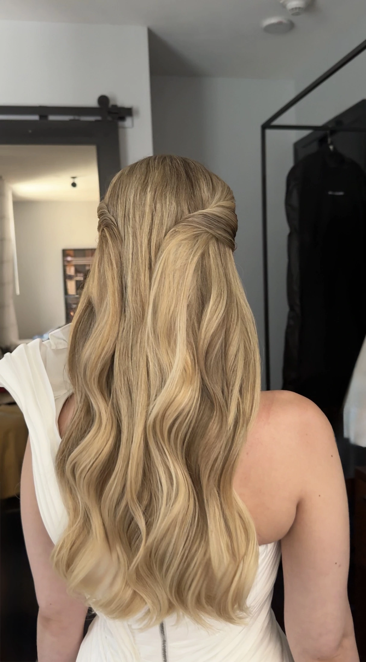 Blonde half-up bridal hairstyle with flowing waves